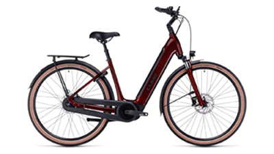 The image shows a dark red Cube Supreme Hybrid Pro e-bike with a low step-through frame.
