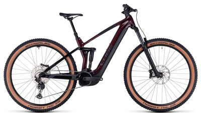 On display is a dark red Cube Stereo Hybrid 140 HPC Pro e-bike with black details.