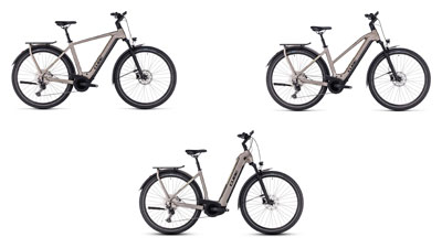 On display are three gray Cube Kathmandu hybrid e-bikes, each with a diamond frame, a trapezoidal frame, and a low step-through frame.