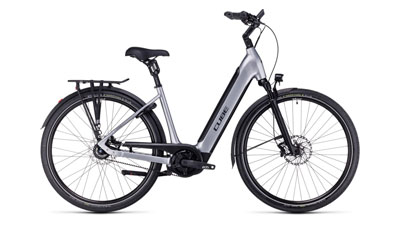 On display is a silver Cube Supreme Hybrid EXC e-bike with a low step-through frame.